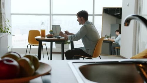 Man Chatting on Laptop in Modern Apartment