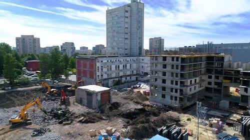 Construction Site with Excavators and New Building