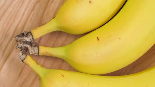 Ripe Yellow Bananas on a Wooden Surface