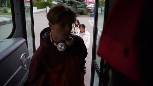 Multiracial Pupils Climbing Steps Getting on Bus