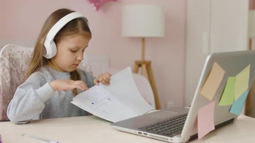 Girl Doing Schoolwork at Desk with Laptop