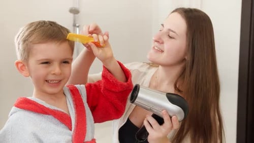 Woman Brushing Child's Hair in Bathroom
