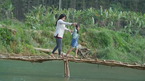 Mother And Her Daughter Walking On Wooden Bridge