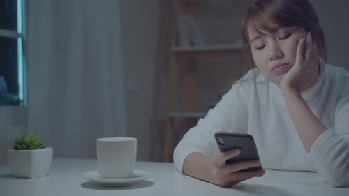 Woman Using Phone Late at Night Indoors