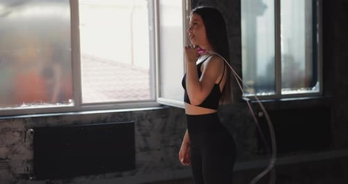 Beautiful Woman Holding Skipping Rope In The Gym