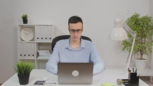 The Man In The Office At The Computer