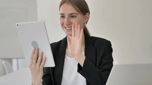 Woman on Tablet Video Call in Bright Office