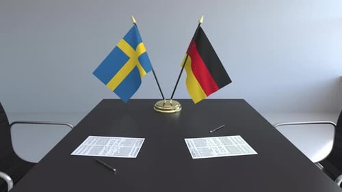 Sweden Germany Flags on Conference Table with Documents