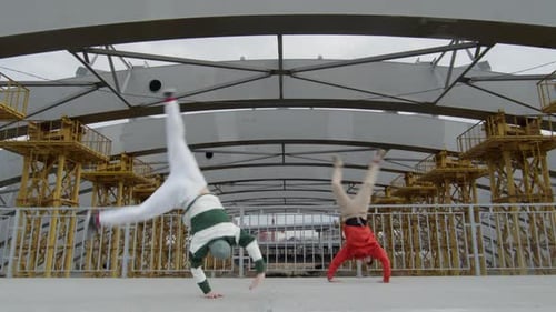 Acrobatic Young Adults Perform Stunts in Urban Setting