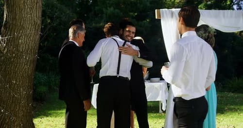 Happy groom hugging guests 4K 4k