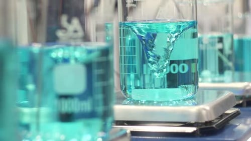Aquamarine Liquid Stirring in Beakers in Laboratory