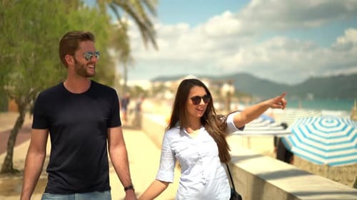 Couple Walking Along Beach Promenade