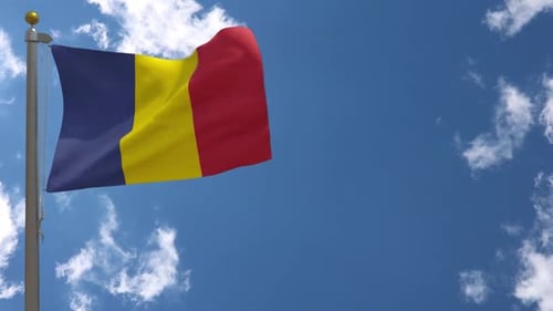 Waving Romanian Flag Against Blue Sky with Clouds