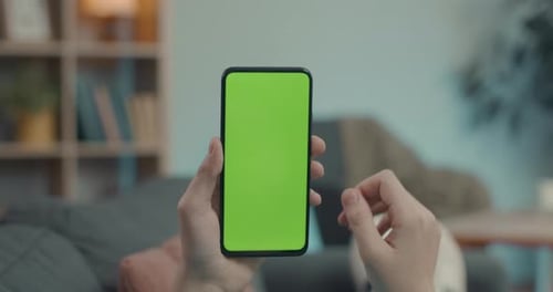 Close Up of Man Using Mobile with Green Screen at Home