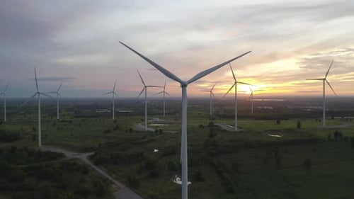 Aerial view of wind turbines or windmills farm field in industry factory. Power, sustainable green