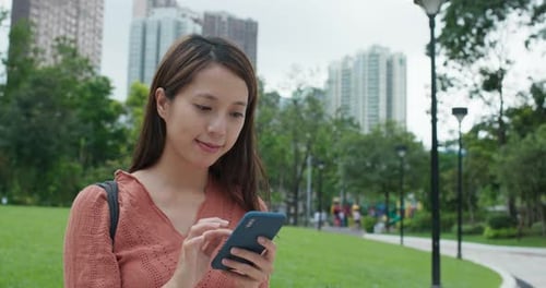 Woman use of mobile phone in the park