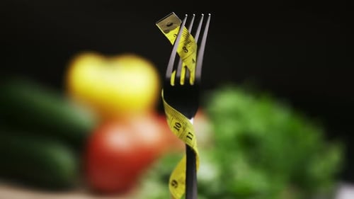 Fork with Measuring Tape and Healthy Food