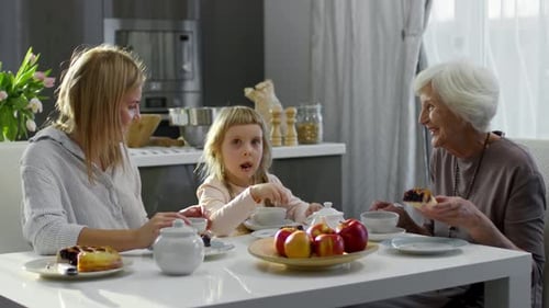 Three Generations Enjoy Cake and Tea Together