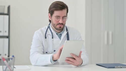 Doctor Uses Tablet at Desk in Bright Office