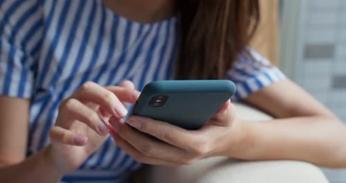Woman Using Mobile Phone Indoors