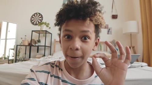 Teen Talking and Gesturing to Camera Indoors