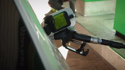 Filling petrol into car at gas station