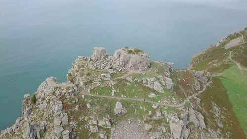 Rotating track around the large rocky stack at the Valley of Rocks, Exmoor, Devon. Person is walking