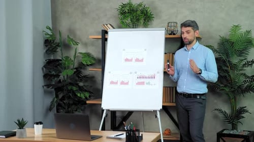 Professional Man Presenting Business Data in an Office
