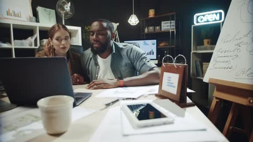 African American Man and Hipster Woman Arguing Near Laptop in Office.