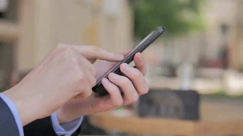 Side View of Hand Typing Message on Smartphone
