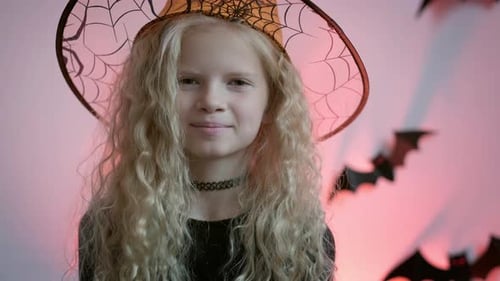 Girl Smiling Wearing a Witch Hat