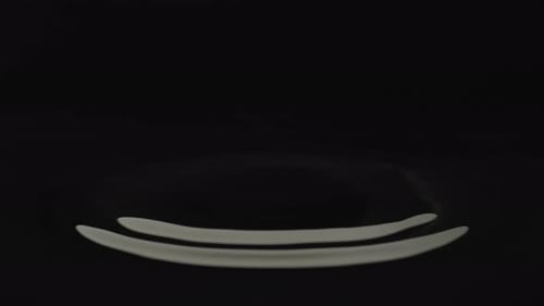 Water drop against black background. Slow Motion. Unedited version is included at the end of clip.