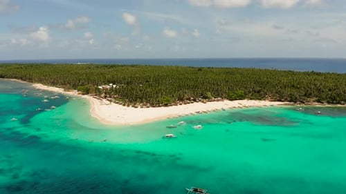 Tropical Daco Island with a Sandy Beach and Tourists