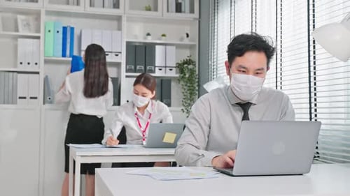 Asian attractive business people wear face mask and working in office.