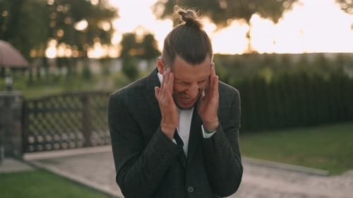 Businessman Has Headache. Disappointment and Failure Concept