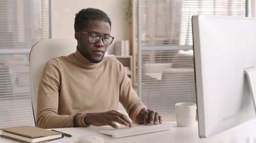 Good-looking African Businessman Working in Office