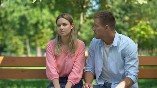Offended Woman Listening Guilty Boyfriend Explanations at Park After Quarrel