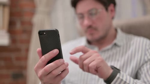 Man Using Mobile Phone in Home Interior