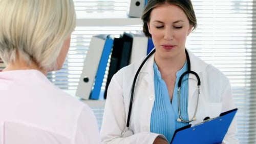 Doctor Speaking with Patient in Medical Office