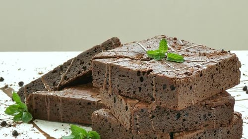 Delicious Brownies Stacked with Chocolate Sauce and Mint