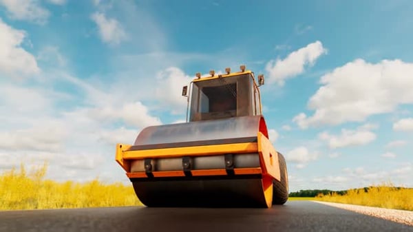 A big roller compacting asphalt on the road. Heavy machine going on hot ...