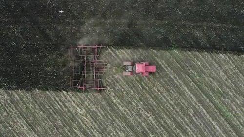 Aerial View of a Tractor Plows Field. View From the Drone.