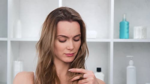 Closeup Portrait of Upset Beautiful Woman Touching Bad Condition Hair Posing at Bathroom Footage