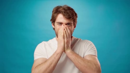 Excited Man Celebrates a Success on Blue Background