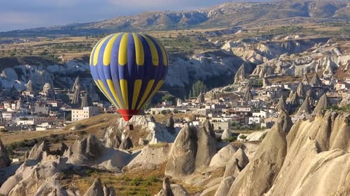 Hot Air Balloon Flying Over Hoodoos and Fairy Chimneys in Goreme Valley Cappadocia, Urgup Turkey