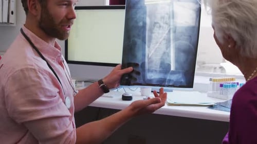 Doctor Explains X-Ray to Patient in Medical Consultation