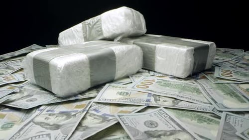 Money and Three Wrapped Objects Under Dim Light