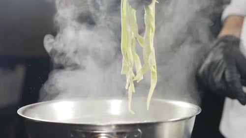 Chef Cooking Pasta in Boiling Water in Restaurant