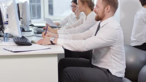 Business Coworkers Sitting on Fitballs in Office