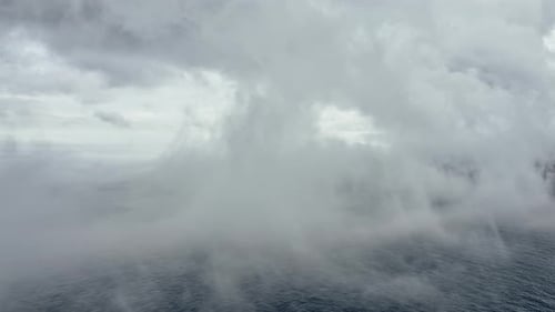 Drone Shot of the Blue Saltwater and Fog Covering the Frame